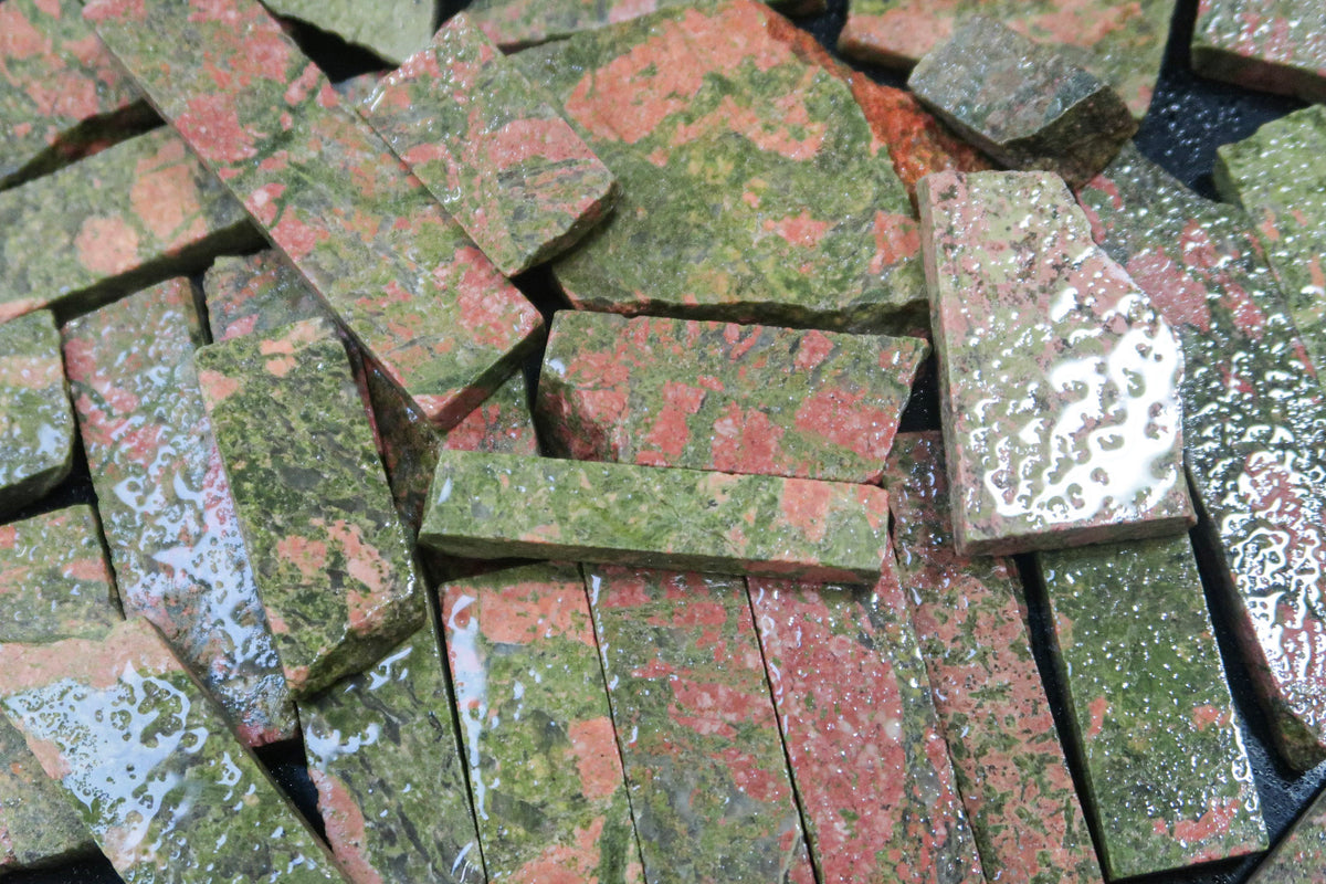 Close up picture of rough unakite stones cut into rectangular pieces. 