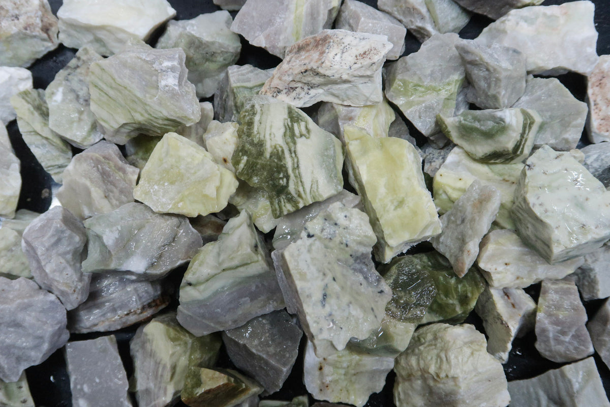 Close up picture of rough yellow serpentine stones approximately 1-2 inches in size
