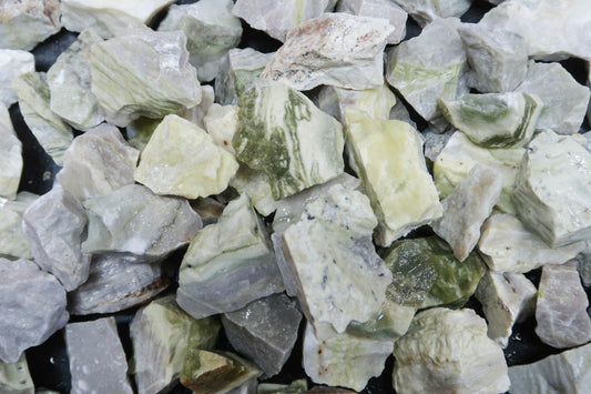 Close up picture of rough yellow serpentine stones approximately 1-2 inches in size