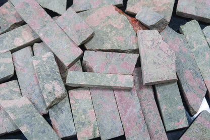Close up picture of rough unakite stones cut into rectangular pieces. 